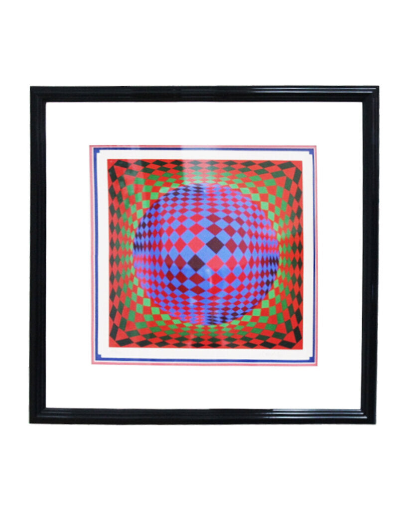 Framed artwork with a geometric design featuring a blue sphere on a red and green patterned background.