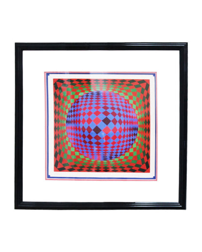 Framed artwork with a geometric design featuring a blue sphere on a red and green patterned background.